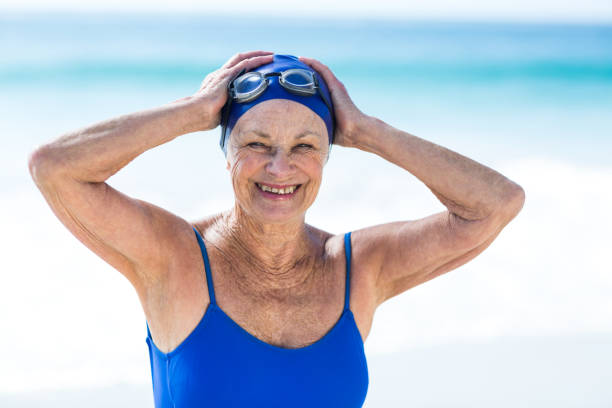 istock Pretty mature woman posing on the beach 700360312