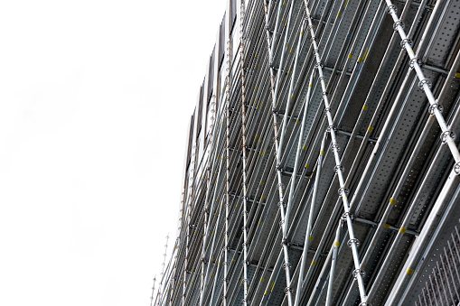 Low angle vie of scaffolding, white background with copy space, full frame horizontal composition