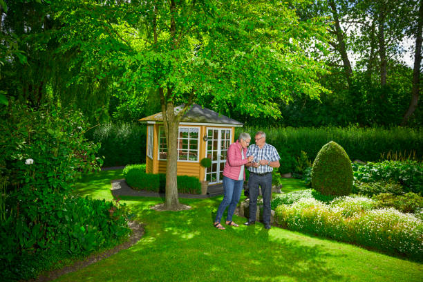 istock Retired couple sipping coffee in their garden 700367324