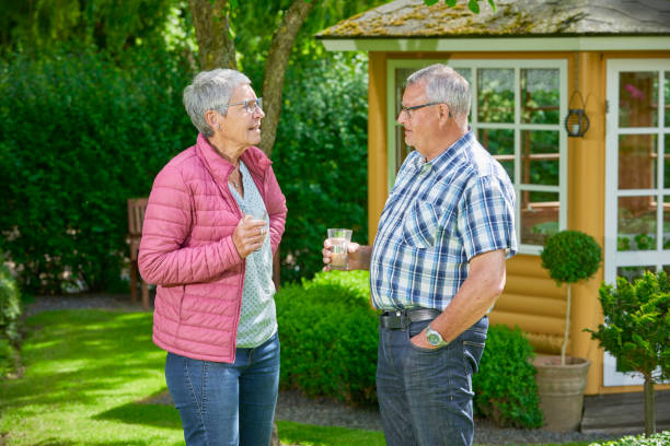 istock Retired couple sipping coffee in their garden 700367376