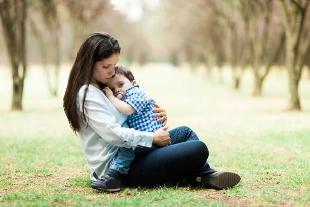 istock Sleepy little boy sitting on mother's lap 700372418