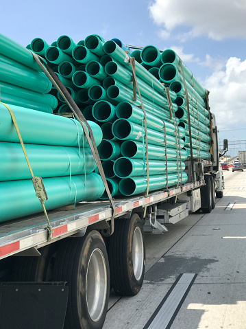 Semi-truck transporting PVC pipes in highway, Miami, Florida, USA