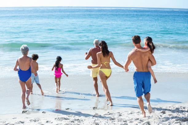 istock Cute multi generation family running in the sea 700375636