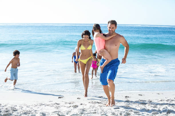 istock Happy family walking on the beach 700376020
