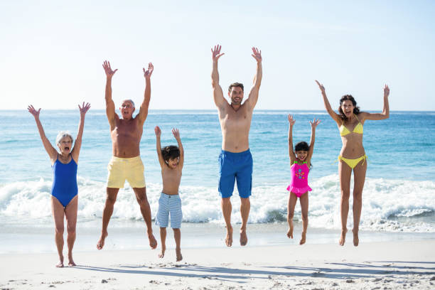 istock Happy family jumping on the beach 700377692