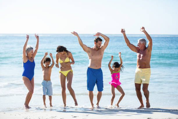 istock Happy family dancing on the beach 700377740