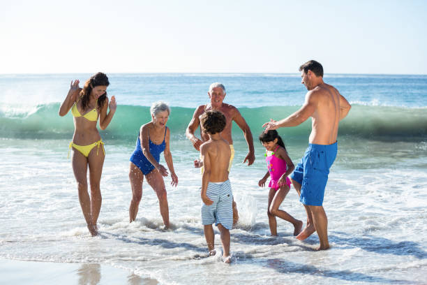 Happy family playing with waves