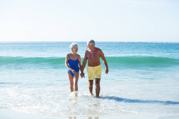 istock Senior couple walking on the water 700378008