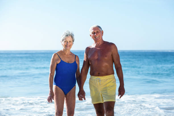 istock Senior couple posing on the water 700378154