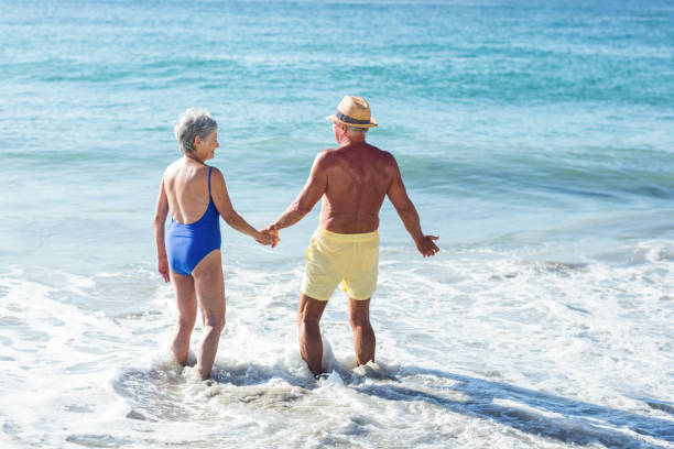 istock Senior couple walking on the water 700378444