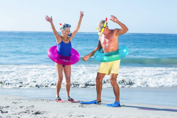 istock Senior couple with beach equipment 700378658