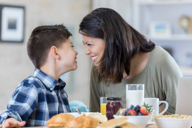 istock Happy mom and son have breakfast at home 700379034