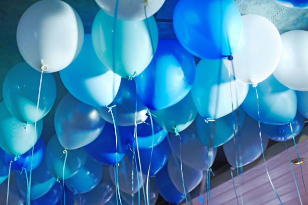 Festive decorated selling with blue tone helium balloons, birthday party stock photo
