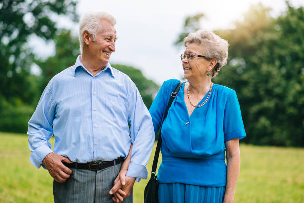 istock Senior couple walking in park 700382904