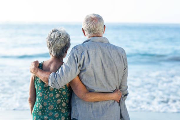 istock Senior couple facing the sea 700398972