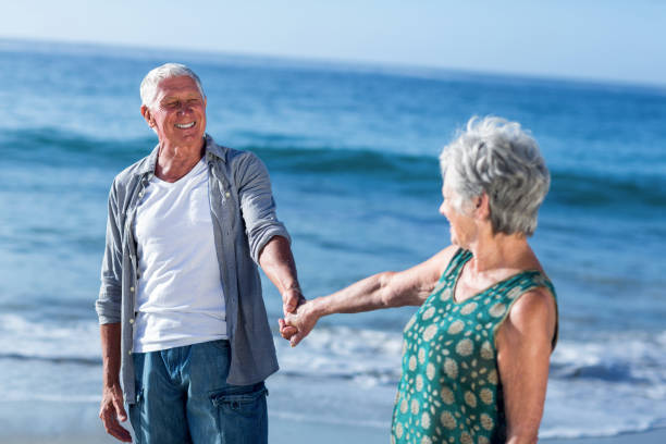 istock Senior couple holding hands 700399246