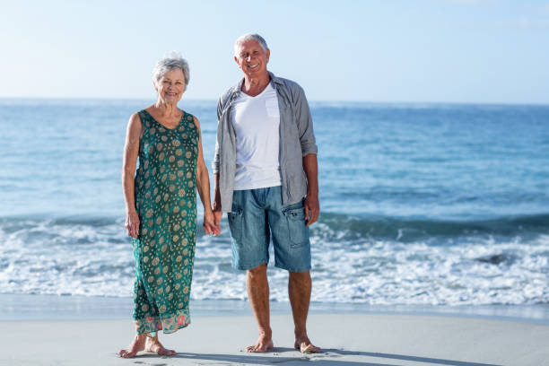 istock Senior couple holding hands 700399412