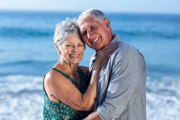 istock Senior couple embracing at the beach 700399812