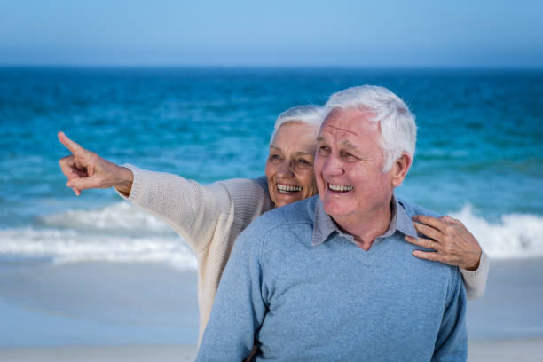 istock Senior couple embracing and pointing 700400108