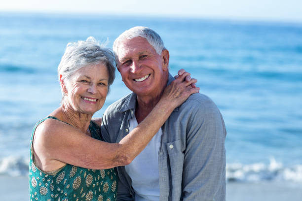 istock Senior couple embracing at the beach 700400166