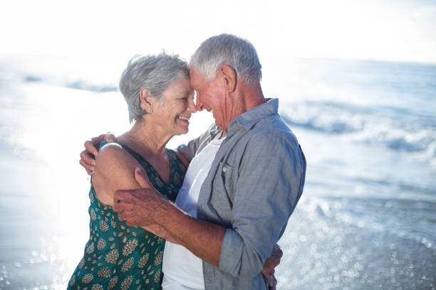 istock Senior couple embracing at the beach 700402208