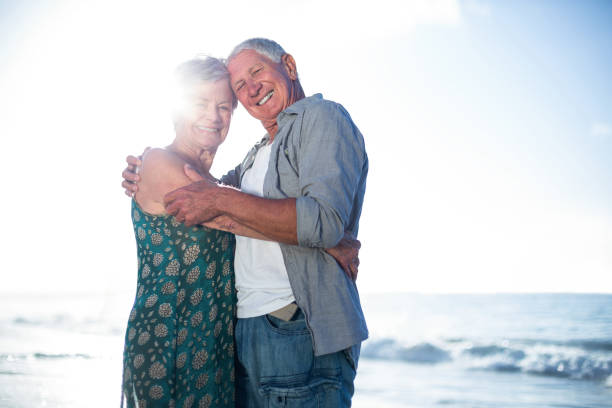 istock Senior couple embracing at the beach 700402228