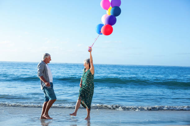 istock Senior couple holding balloons 700404460