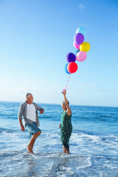 istock Senior couple holding balloons 700412706