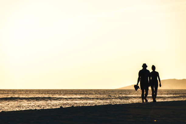 istock Silhouette of two friends 700415148