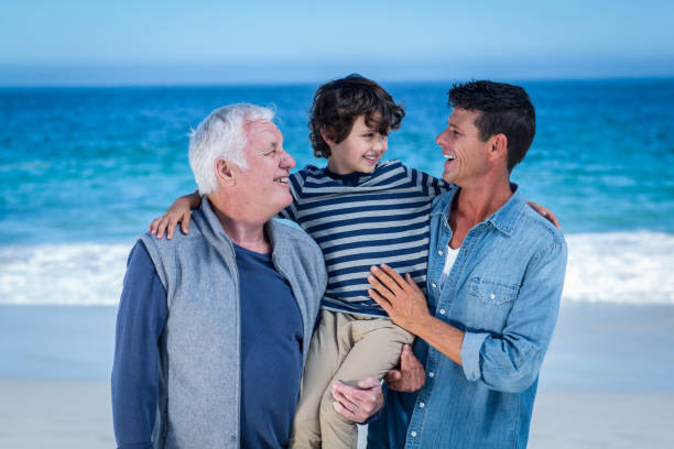 istock Male family members posing at the beach 700435756