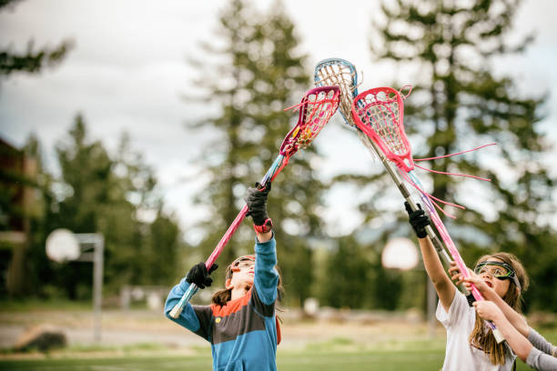 Going for it Girls learning to play Lacrosse kids lacrosse stock pictures, royalty-free photos & images