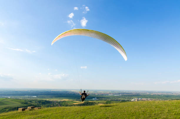 istock Man flying with paraglider on beautiful sunny day 700454250