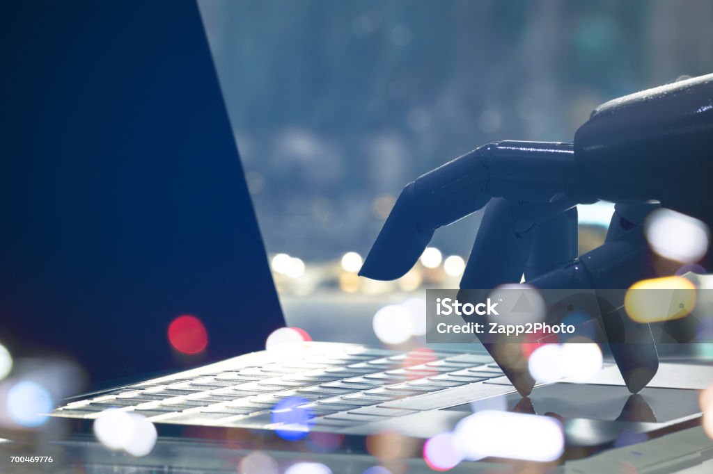 Artificial intelligence , chatbot , cyber communication , robot world and robo advisor. Robot finger point to laptop button with bokeh background. Advice Stock Photo