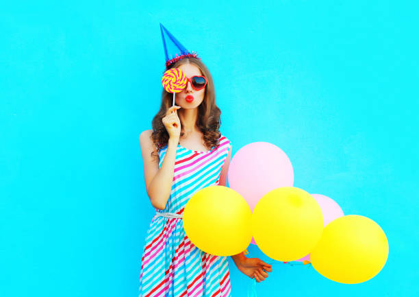 portrait woman in a birthday cap holds an air colorful balloons - personal accessory balloon beauty birthday imagens e fotografias de stock
