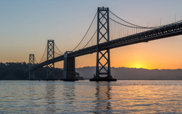 istock Sun Under the Bay Bridge at Dawn 700495382