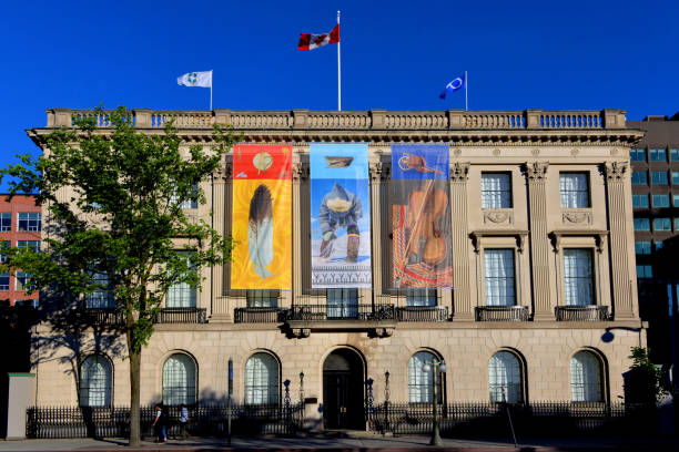 National Indigenous Peoples Day in Ottawa, Canada Ottawa, Canada - June 21, 2017:  Three native themed banners are added to the former US embassy, across from Parliament Hill, during a ceremony on National Indigenous Peoples Day, formerly known as National Aboriginal Day.  It was recently announced the building will be converted to a centre dedicated to Indigenous people. indigenous peoples day stock pictures, royalty-free photos & images