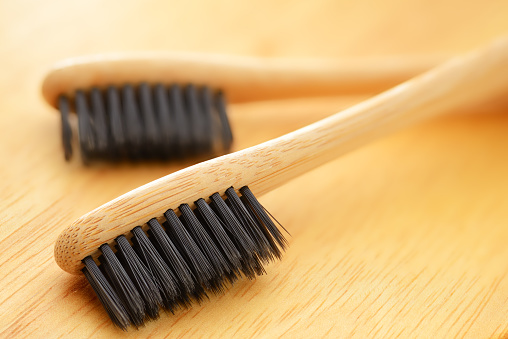 Wooden eco bamboo toothbrushes with black bristle macro shot
