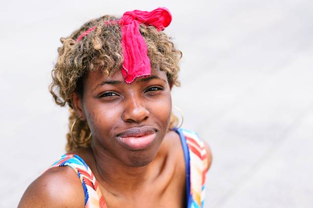 istock Young woman smiling at the camera 700528138