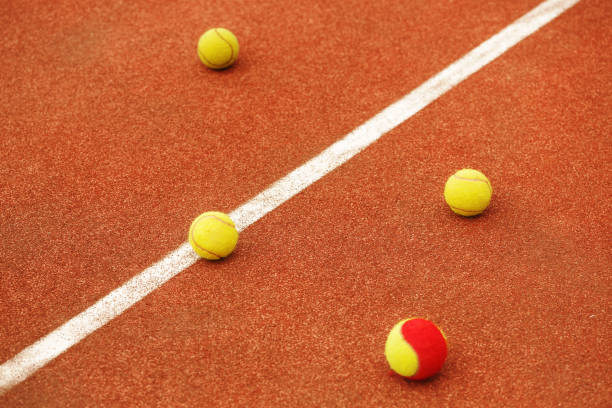 istock Ball on tennis court background 700528408
