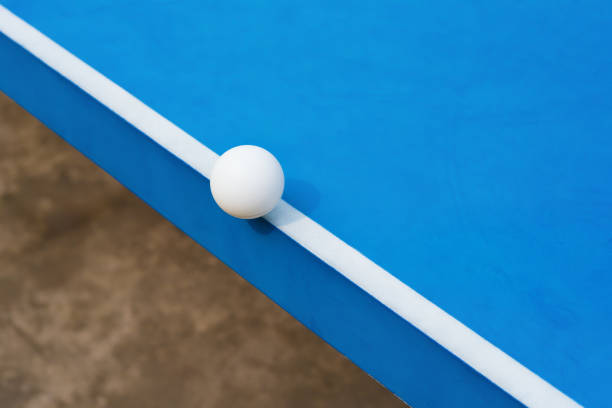 istock white pingpong ball hits the edge of a blue pingpong table 700540744