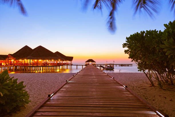 Water cafe at sunset - Maldives Water cafe at sunset - Maldives vacation background water bungalow maldives stock pictures, royalty-free photos & images