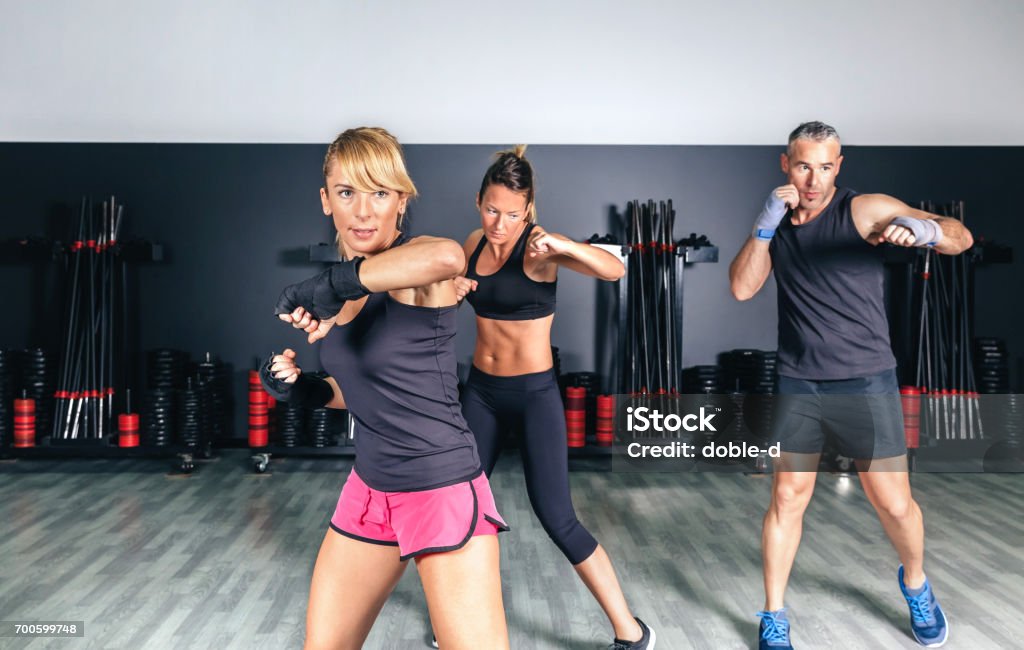 People training boxing in a fitness center Group of people in a hard boxing training on fitness center Gym Stock Photo