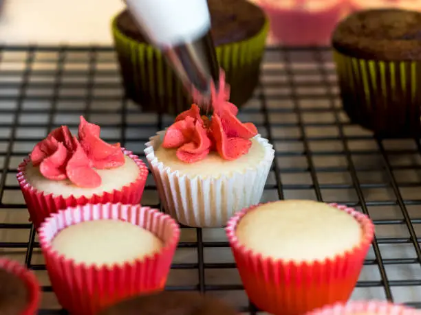 A baking project by grandmother making cupcakes for a birthday party. Made and photographed in our home. Companion pictures to Seniors at Home CreativeContentBrief 700034773 :   Bold Primary Colours