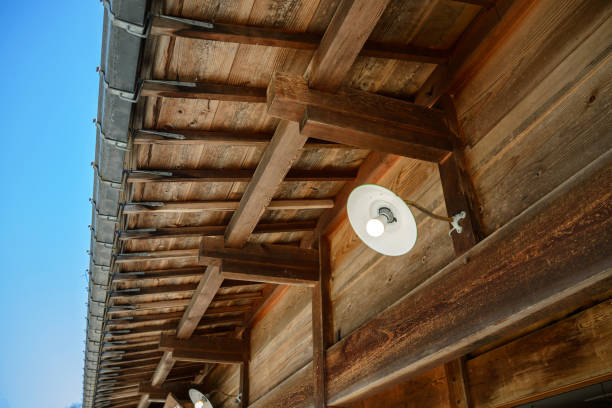 istock Naked electric bulb under the eaves 700600314