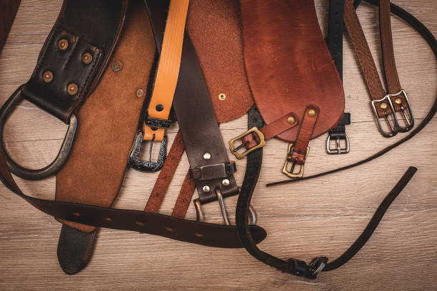 istock leather belts in wooden background 700603358