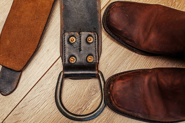 istock Pair of cowboy boots and leather belt 700605844