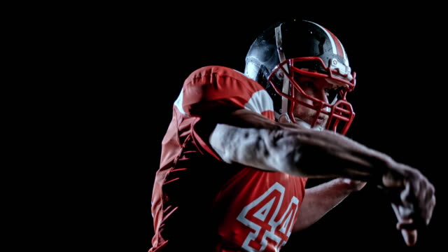 SPEED RAMP American football player in red jersey throwing the ball on a black background