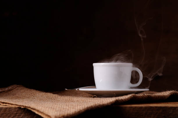 istock Steaming coffee cup and spoon on jute 700609006