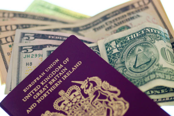 uk european union passport and us dollars - twenty dollar bill us currency currency fanned out imagens e fotografias de stock