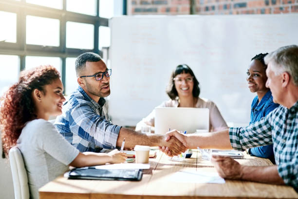 Always be ready for a challenge Shot of a team of entrepreneurs collaborating in a modern office dealing cards stock pictures, royalty-free photos & images